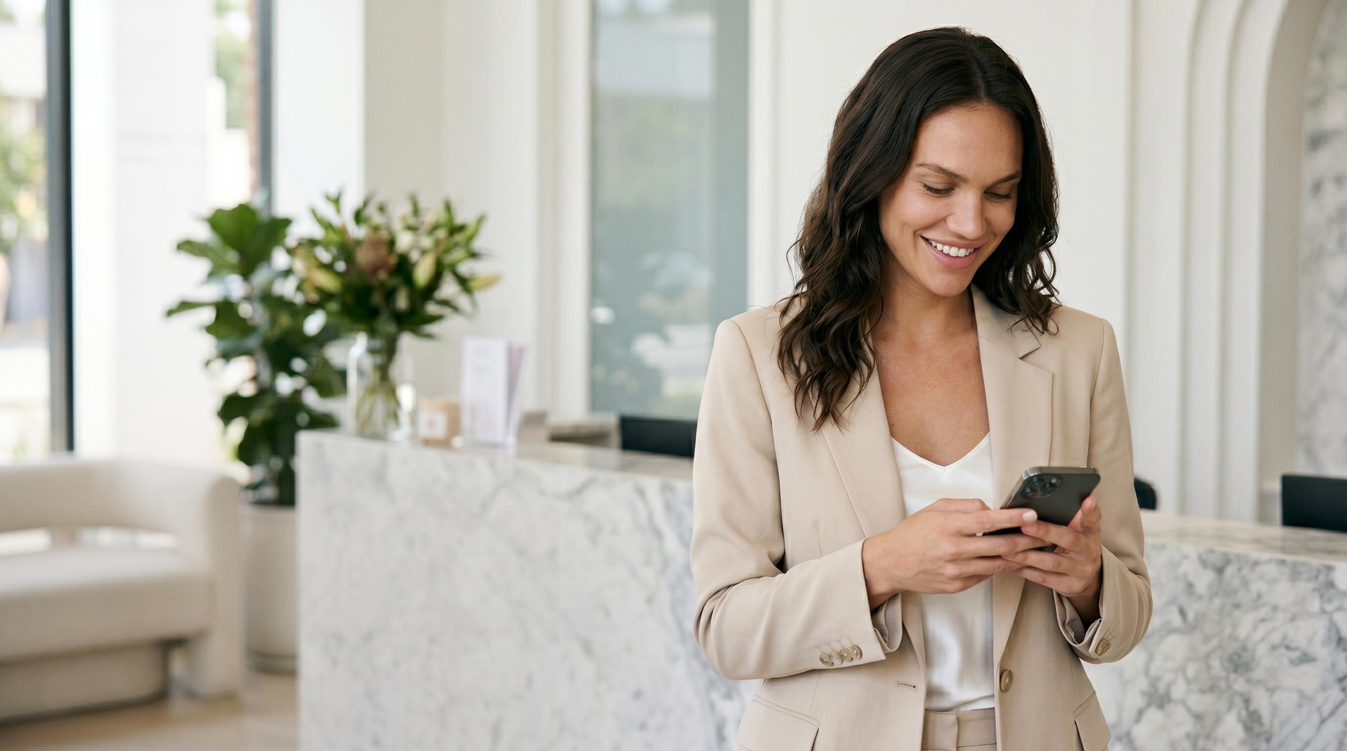 A clinic professional reading a WhatsApp message in a bright pastel reception lobby